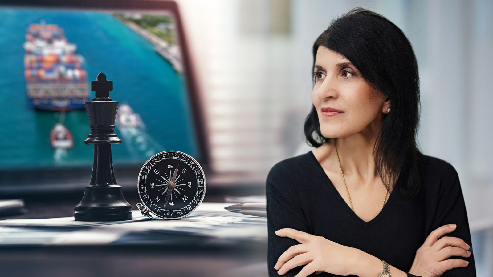 Woman standing in front of compass and chess piece